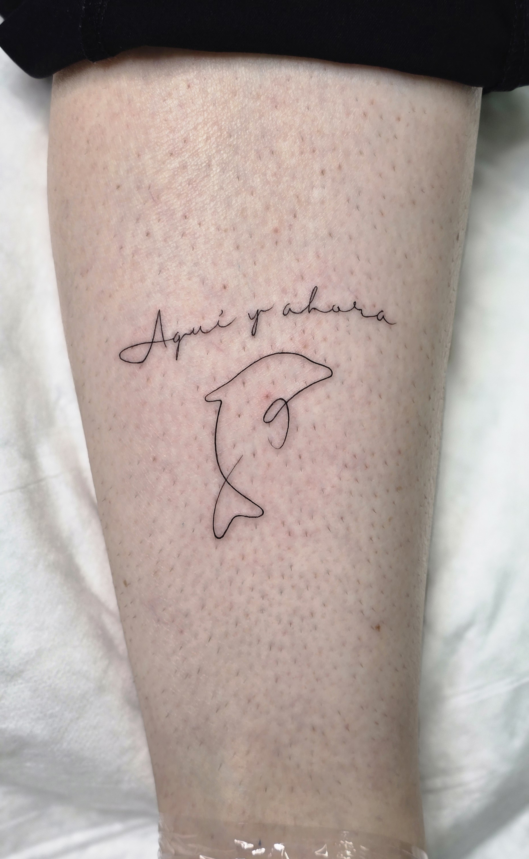 Fine line dolphin tattoo with script, Funchal Madeira souvenir