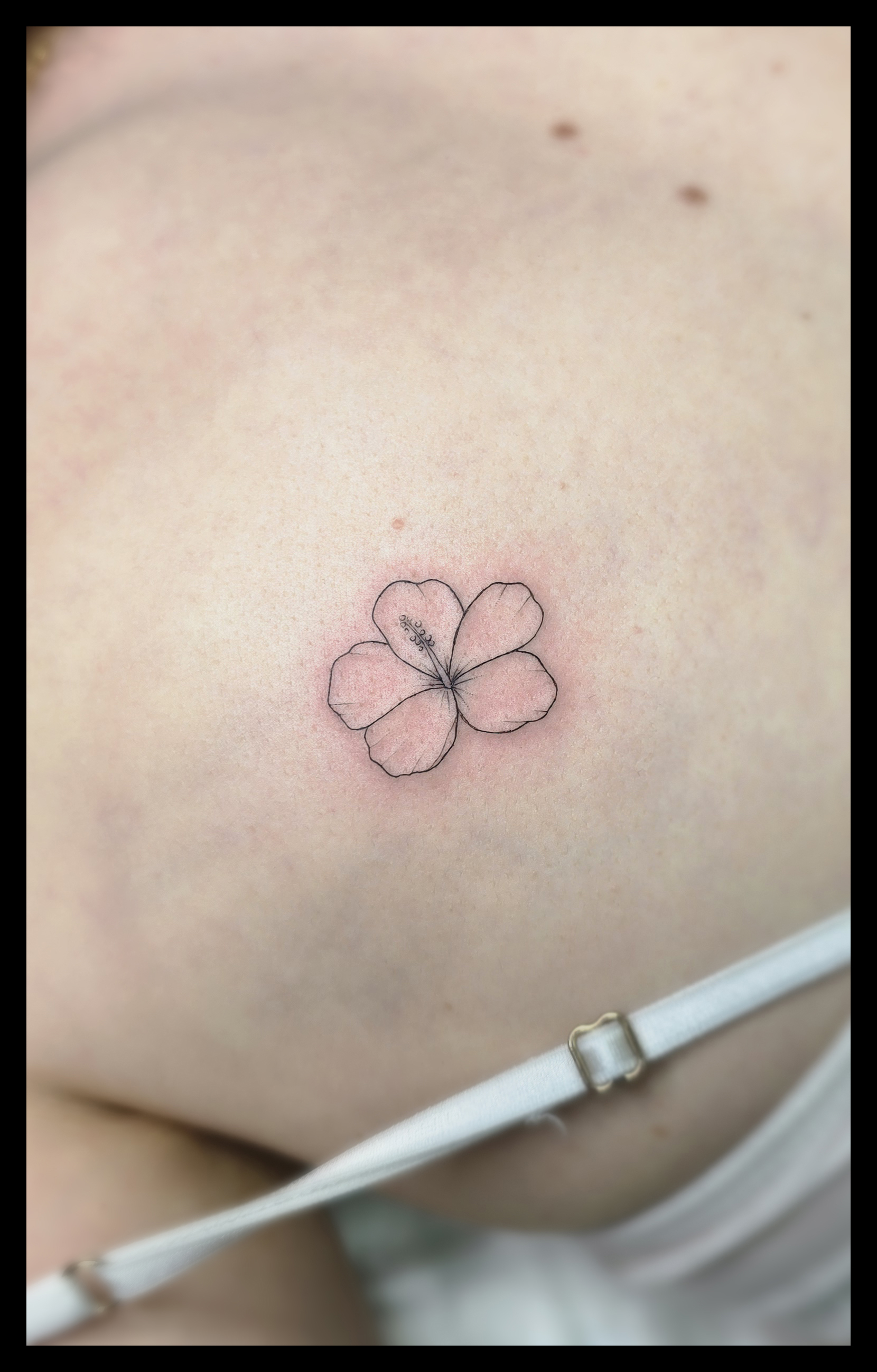 Fine line hibiscus flower tattoo on shoulder, Funchal Madeira souvenir
